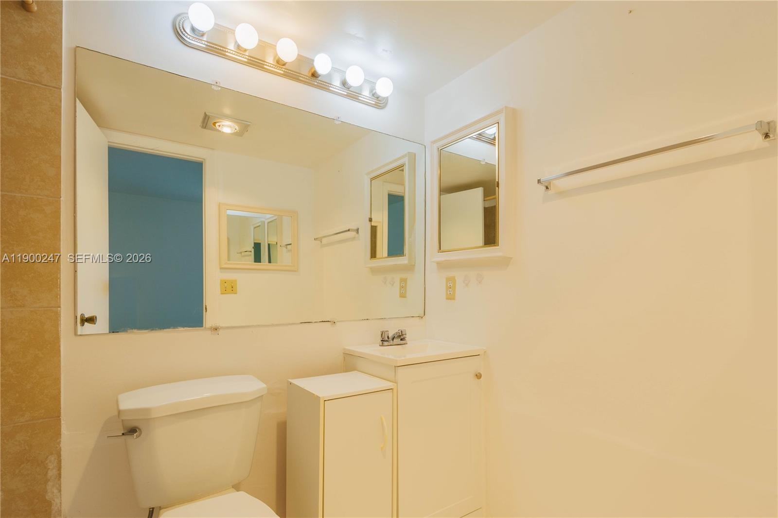 303 Preston H, Unit 303 Boca Raton, FL 33434 - Photo 20 of 50 a bathroom with a sink mirror vanity and toilet
