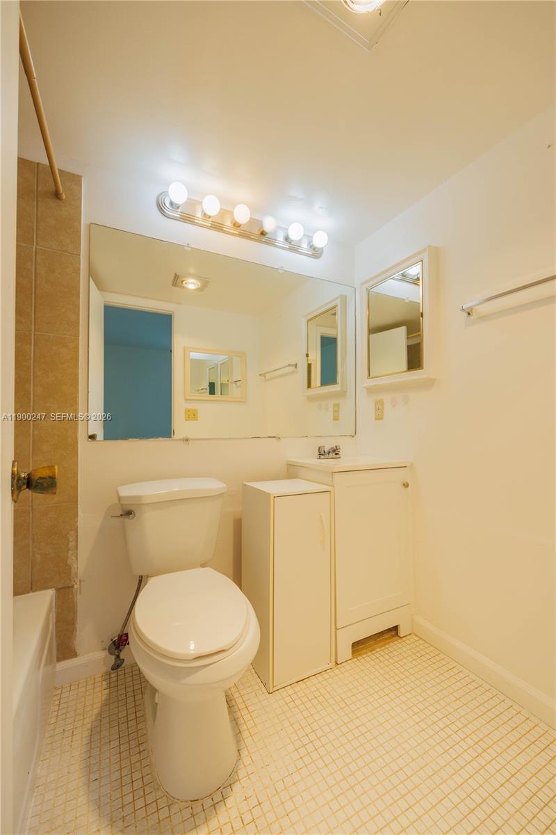 303 Preston H, Unit 303 Boca Raton, FL 33434 - Photo 21 of 50 a bathroom with a toilet sink and mirror