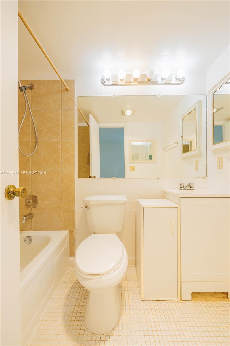 303 Preston H, Unit 303 Boca Raton, FL 33434 - Photo 23 of 50 a bathroom with a toilet sink and mirror