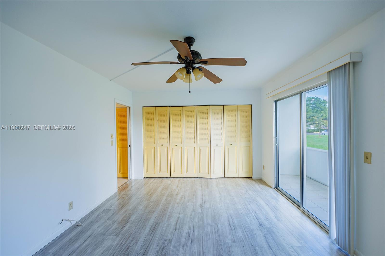 303 Preston H, Unit 303 Boca Raton, FL 33434 - Photo 29 of 50 a view of a room with wooden floor and a ceiling fan