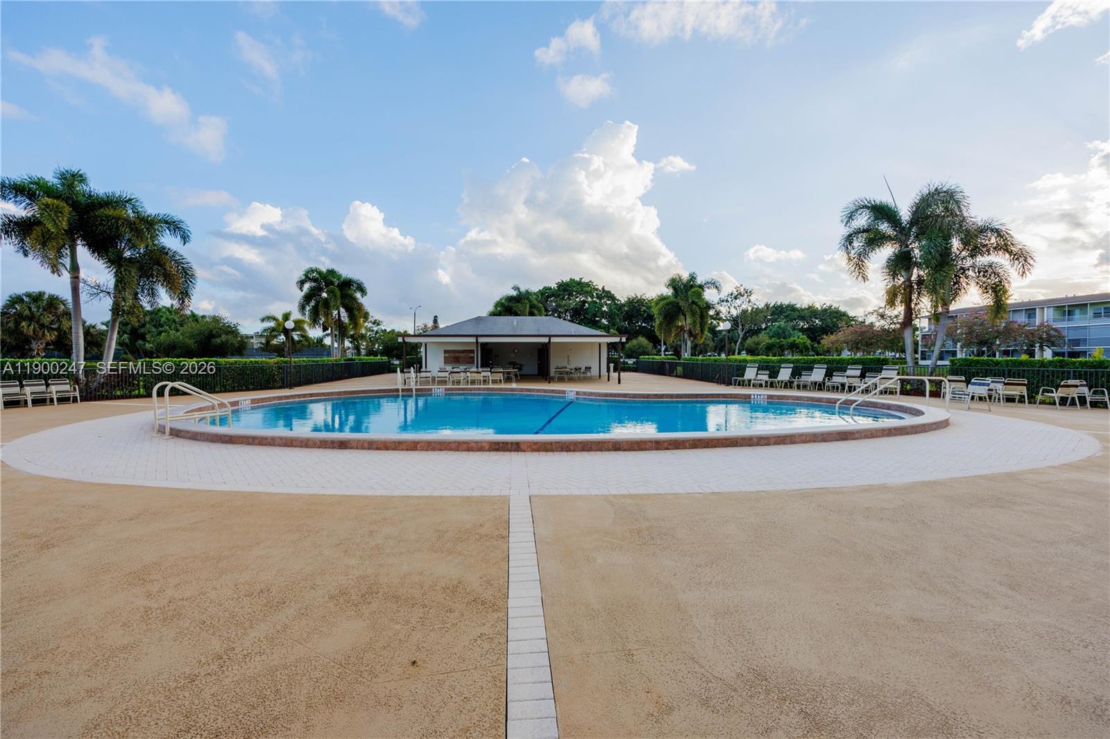 303 Preston H, Unit 303 Boca Raton, FL 33434 - Photo 33 of 50 a view of a swimming pool and a yard