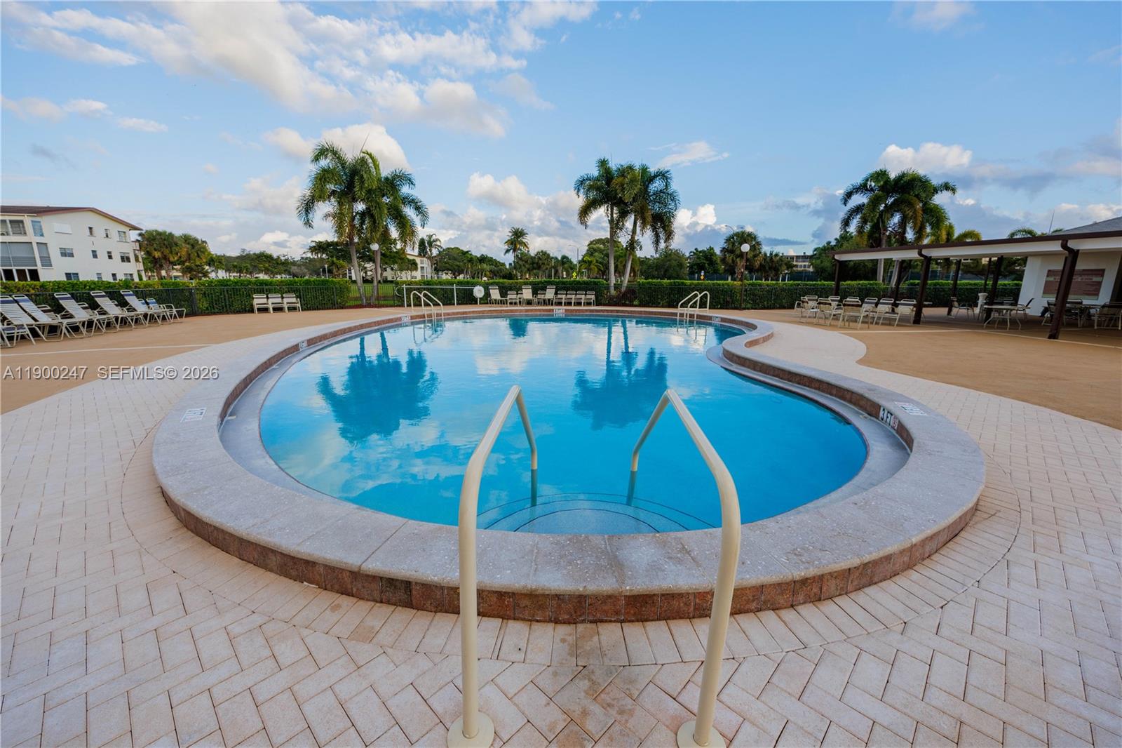 303 Preston H, Unit 303 Boca Raton, FL 33434 - Photo 35 of 50 a view of a swimming pool with outdoor seating and plants
