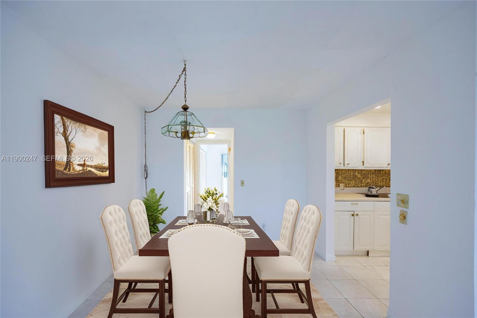 303 Preston H, Unit 303 Boca Raton, FL 33434 - Photo 49 of 50 a dining room with furniture a window and a chandelier