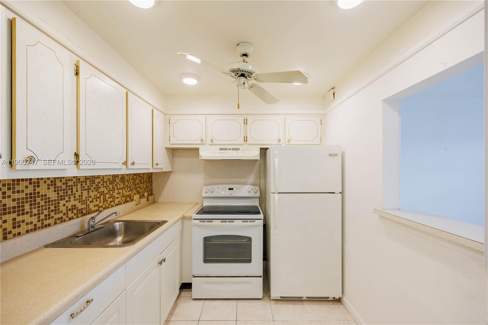 303 Preston H, Unit 303 Boca Raton, FL 33434 - Photo 9 of 50 a white refrigerator freezer sitting inside of a kitchen