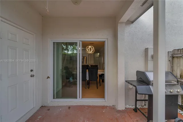 a view of a hallway with wooden floor and a living room