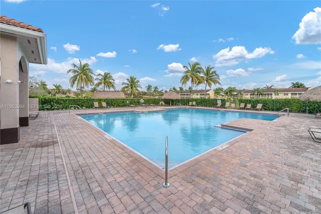 a view of a swimming pool with an outdoor seating