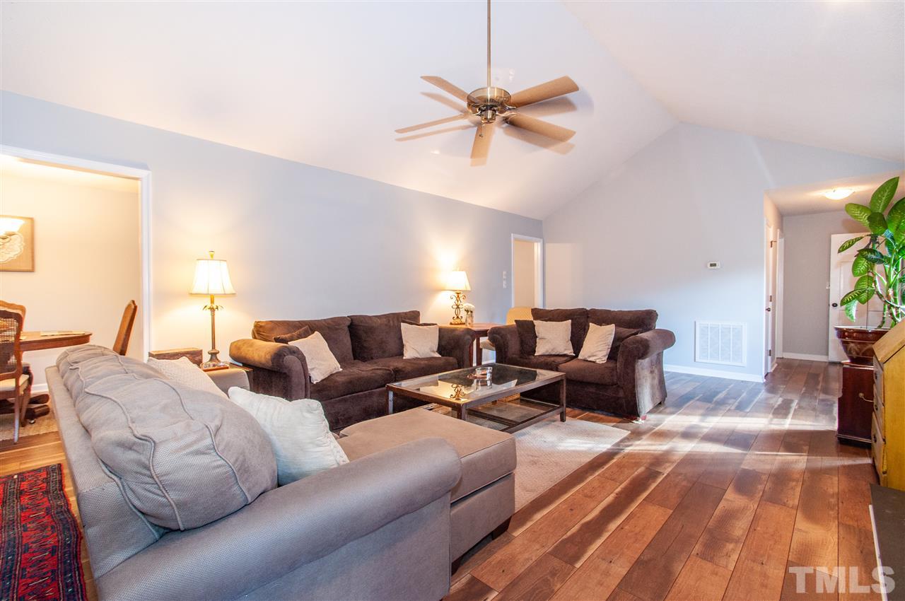 2712 Rue Sans Famille Raleigh, NC 27607 - Photo 3 of 28 a living room with furniture and a chandelier