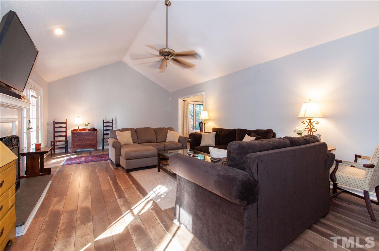 2712 Rue Sans Famille Raleigh, NC 27607 - Photo 5 of 28 a living room with furniture and a flat screen tv