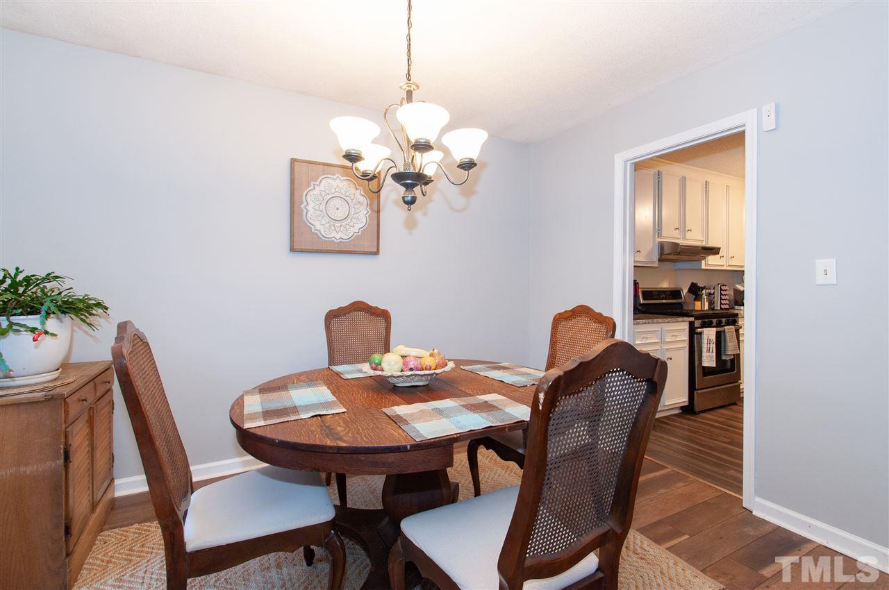 2712 Rue Sans Famille Raleigh, NC 27607 - Photo 6 of 28 a view of a dining room with furniture and chandelier