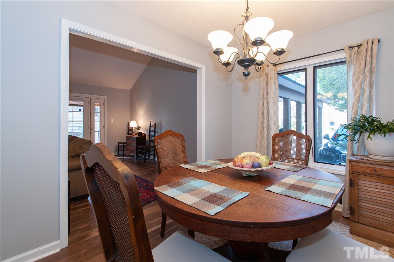 2712 Rue Sans Famille Raleigh, NC 27607 - Photo 8 of 28 a view of a dining room with furniture wooden floor and chandelier
