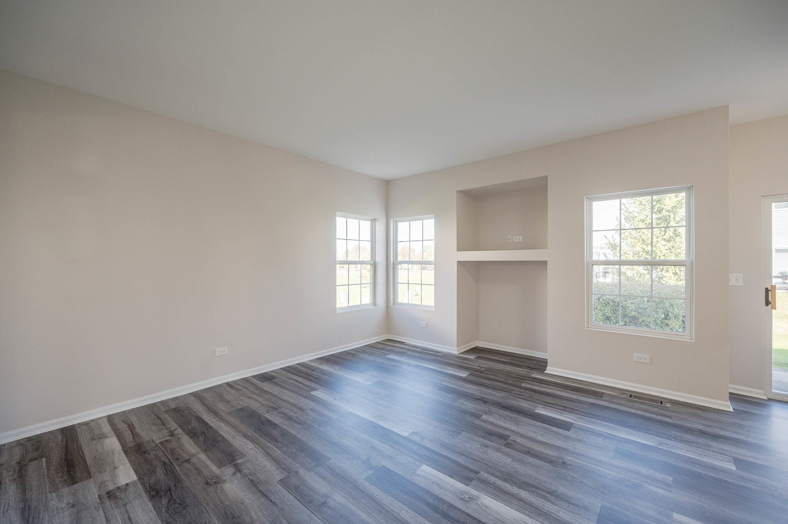 1036 Key Largo Drive Romeoville, IL 60446 - Photo 8 of 16 an empty room with wooden floor and windows