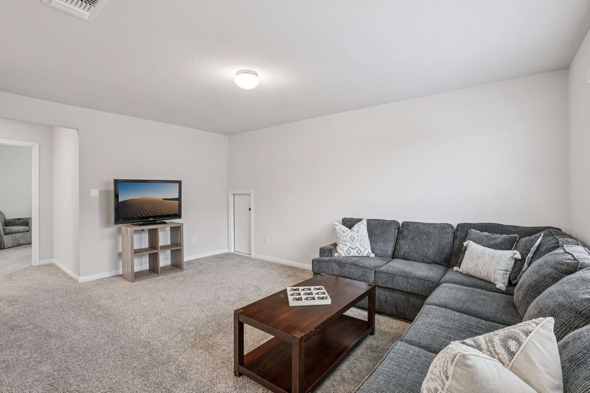 204 Swinging H Lane Georgetown, TX 78633 - Photo 22 of 39 Living area with light gray carpeting and white walls