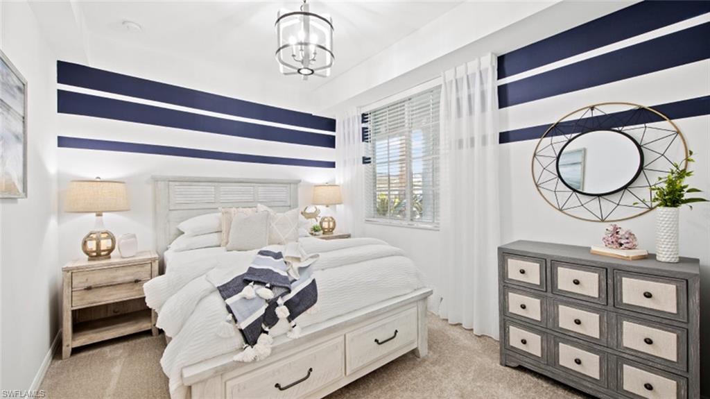 5583 Double Eagle Circle, Unit 4126 Ave Maria, FL 34142 - Photo 11 of 29 a bedroom with a bed a mirror and a window