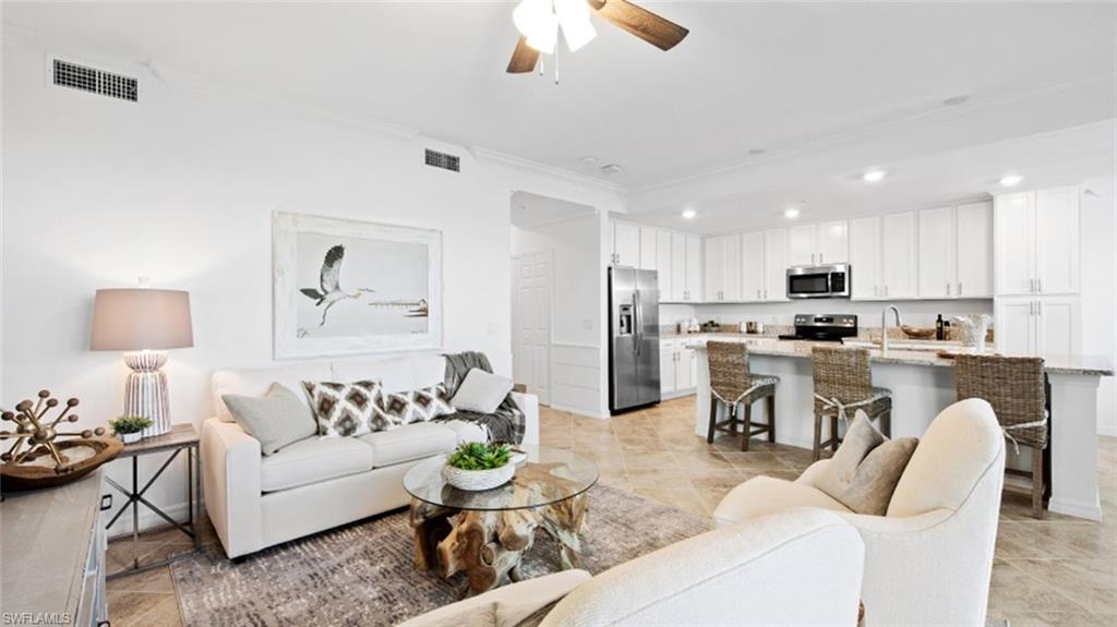 5583 Double Eagle Circle, Unit 4126 Ave Maria, FL 34142 - Photo 9 of 29 a living room with furniture kitchen and a chandelier