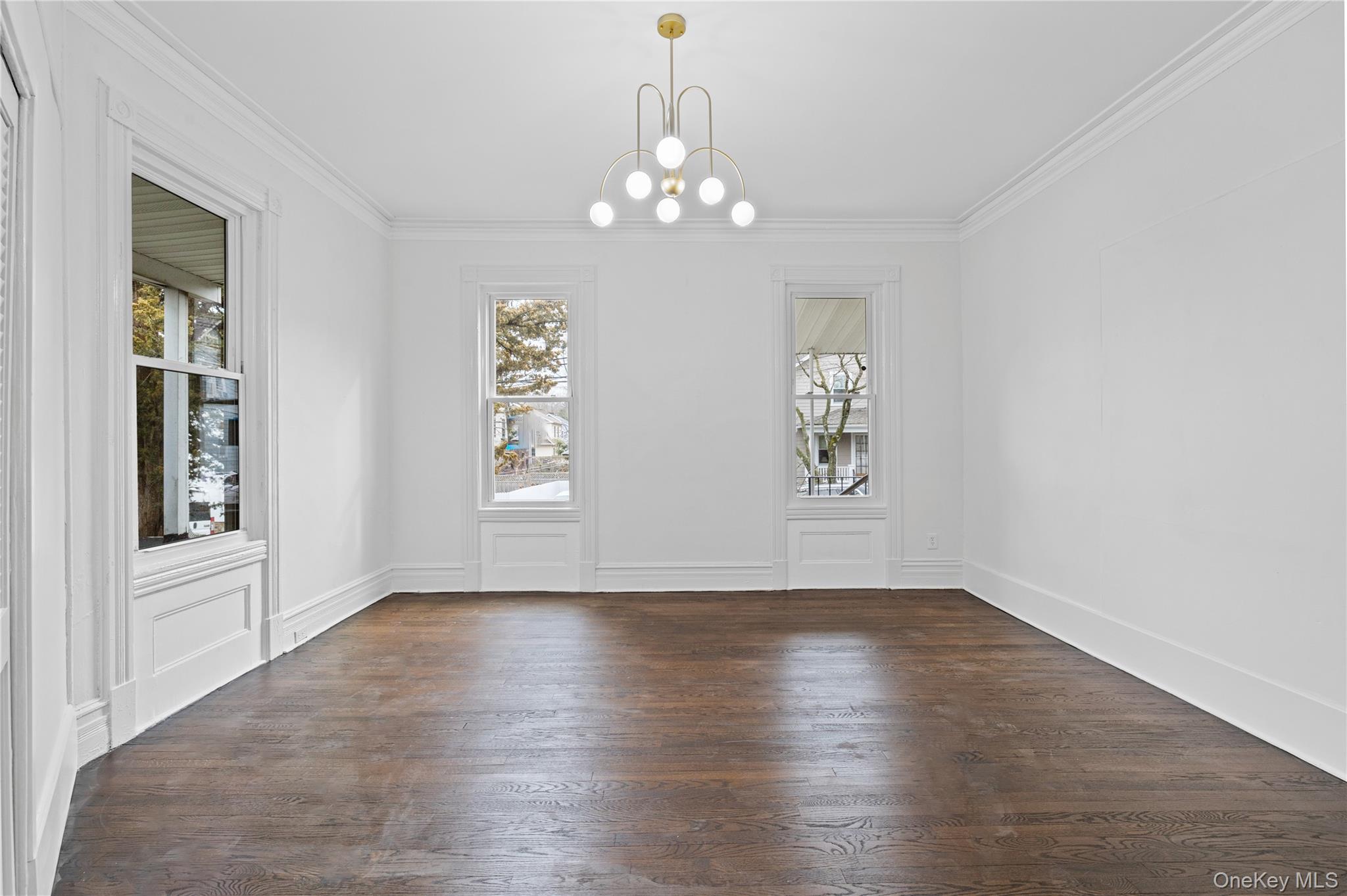 1 Elizabeth Place, Unit 1F Nyack, NY 10960 - Photo 12 of 23 Unfurnished dining area featuring dark wood-style flooring, ornamental molding, plenty of natural light, and a chandelier