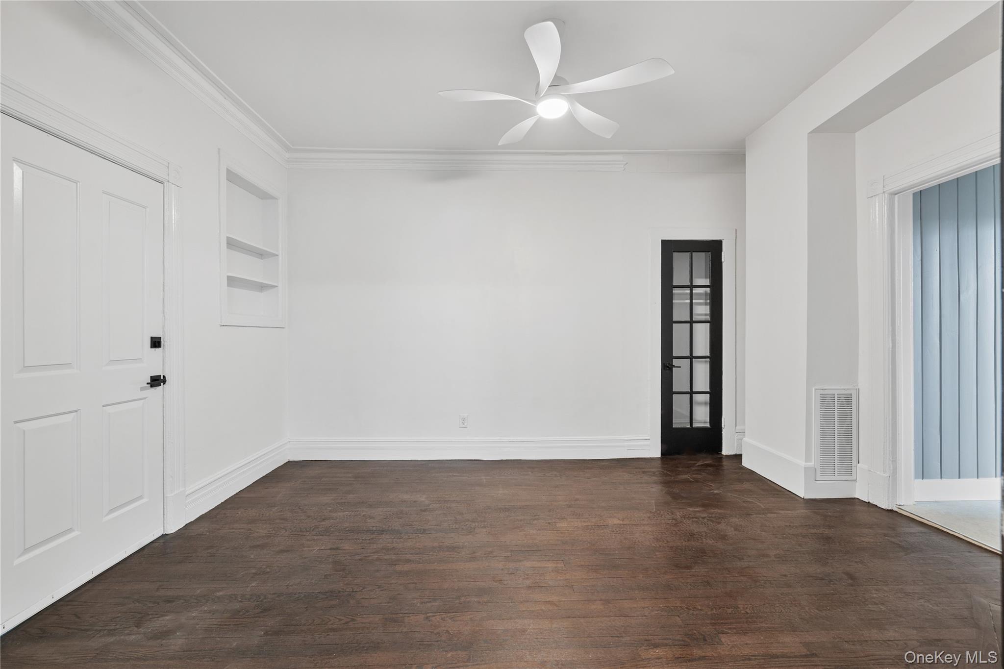 1 Elizabeth Place, Unit 1F Nyack, NY 10960 - Photo 8 of 23 Unfurnished room with visible vents, built in features, ceiling fan, and dark wood finished floors