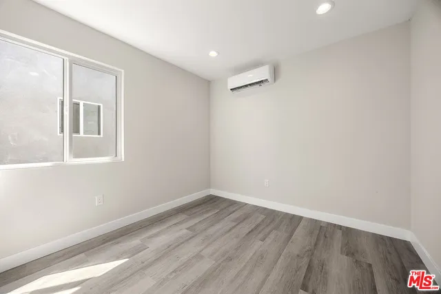 a view of a room with wooden floor and window