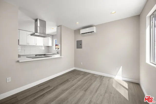 a view of a kitchen with wooden floor and windows