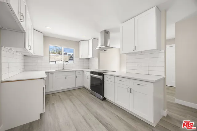 a kitchen with white cabinets sink and white appliances