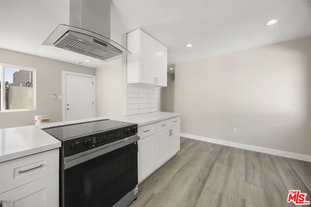 a kitchen with a sink stove and cabinets