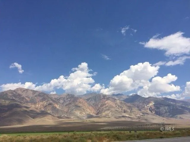 a view of mountain with lake and trees in the back