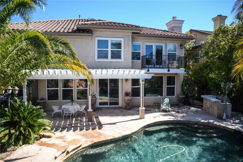 20370 Vía Cellini Porter Ranch, CA 91326 - Photo 15 of 17 a front view of a house with swimming pool and glass windows