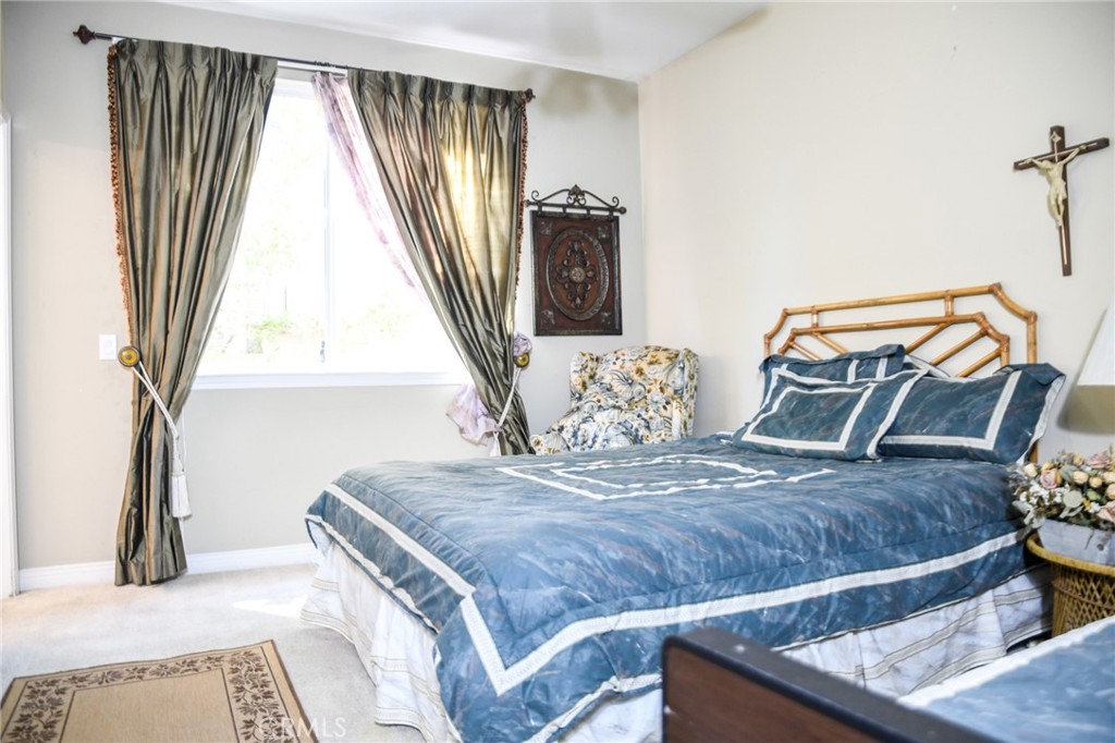 20370 Vía Cellini Porter Ranch, CA 91326 - Photo 8 of 17 a bedroom with a bed and wooden floor