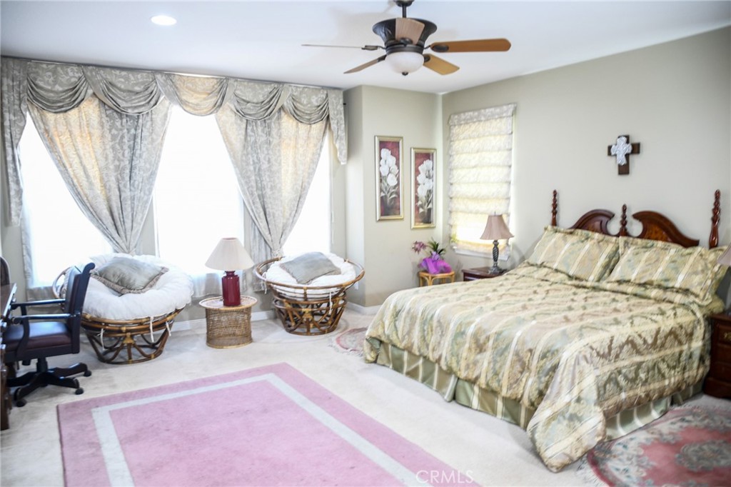 20370 Vía Cellini Porter Ranch, CA 91326 - Photo 9 of 17 a spacious bedroom with a bed and a window