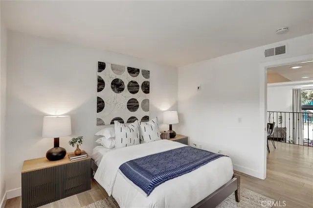 a bedroom with a bed and a potted plant