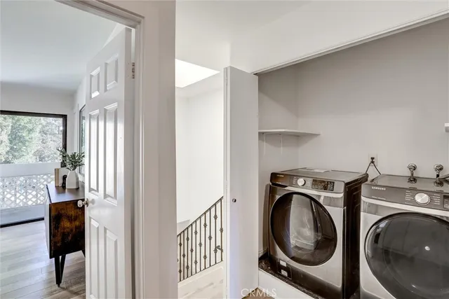 a view of a hallway with washer and dryer
