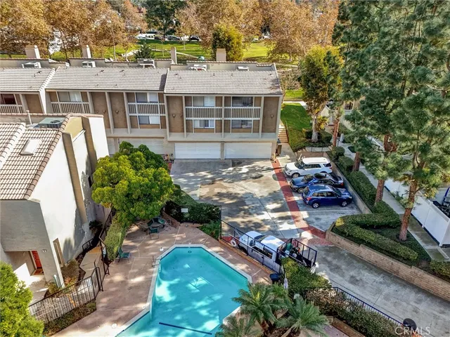a view of a swimming pool with a patio and plants