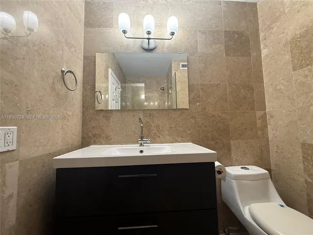 a bathroom with a sink a large mirror and a shower
