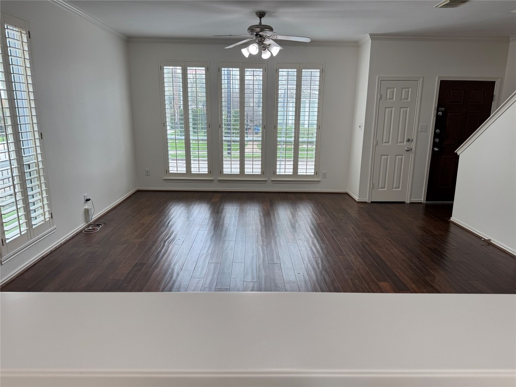 1908 Bailey Street Houston, TX 77006 - Photo 9 of 40 Here's the living room view, from the kitchen sink. The floors are hand-scraped wood. There's a coat closet beside the front door.