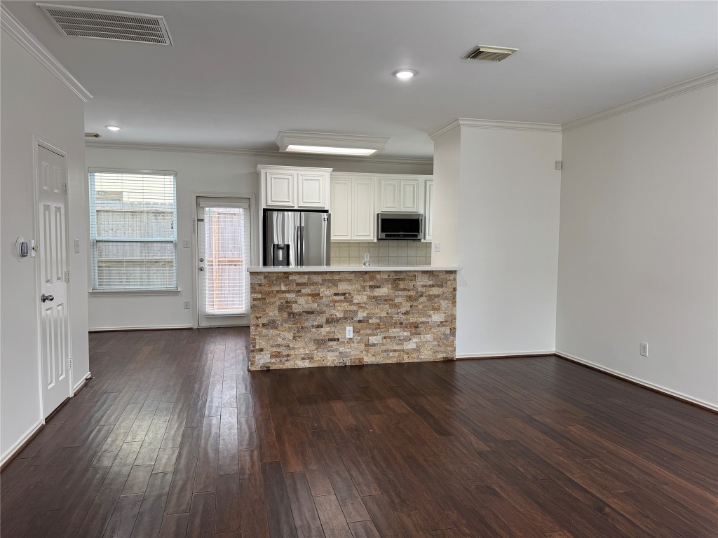 1908 Bailey Street Houston, TX 77006 - Photo 3 of 40 This is your view from the living room, looking toward the kitchen and back door. There's a decorative stacked limestone wall at the breakfast bar so you don't have to worry about marking it up with your shoes.