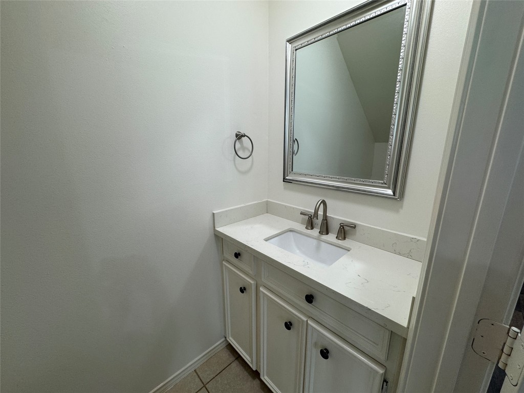 1908 Bailey Street Houston, TX 77006 - Photo 5 of 40 The powder bath is right off the living room and it has a wide vanity with lots of storage space. The toilet is tucked under the stairs, opposite the vanity.