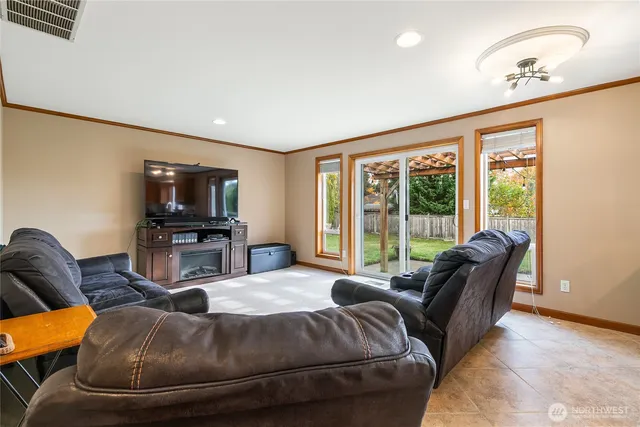 a living room with furniture a large window and a flat screen tv