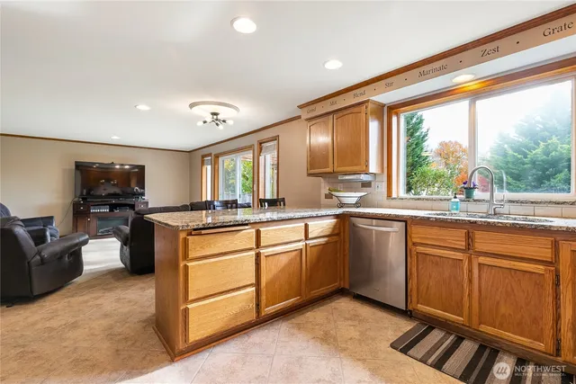 a kitchen with stainless steel appliances granite countertop sink stove and refrigerator
