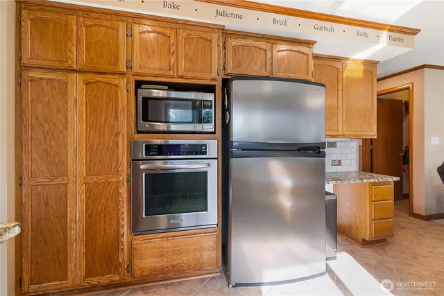 a kitchen with granite countertop cabinets and stainless steel appliances