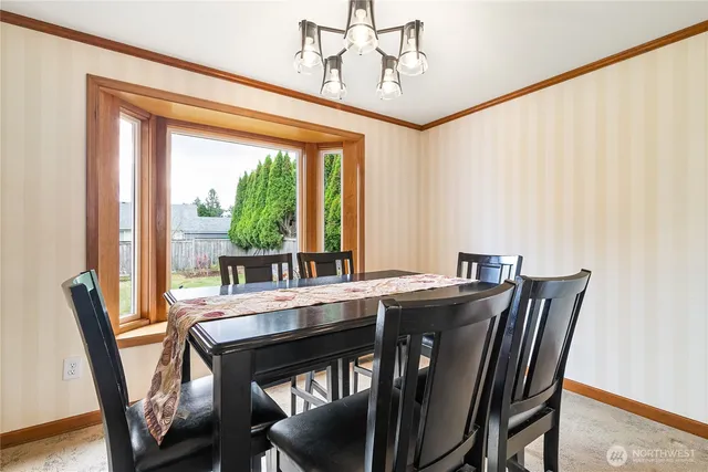 a view of a dining room with furniture window and outside view