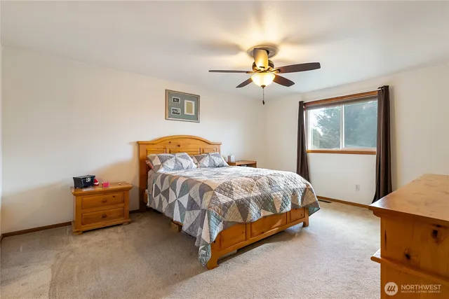 a bedroom with a bed dresser and a window