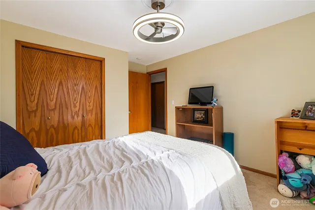 a bedroom with a bed and a chandelier