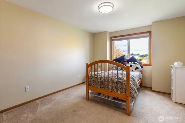 a view of bedroom with furniture and a window