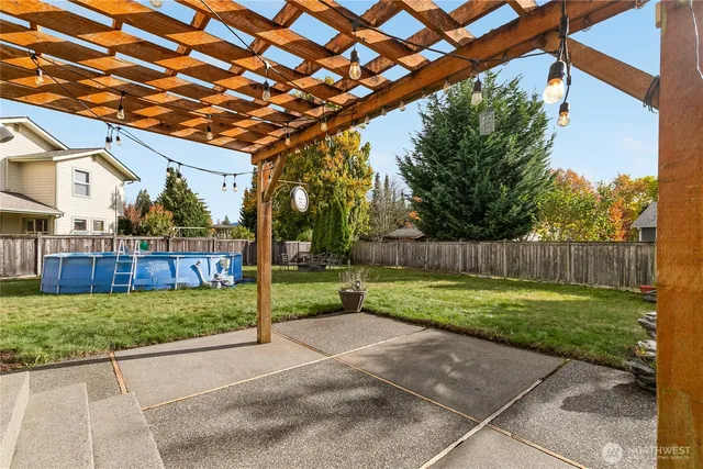 a view of backyard with wooden fence