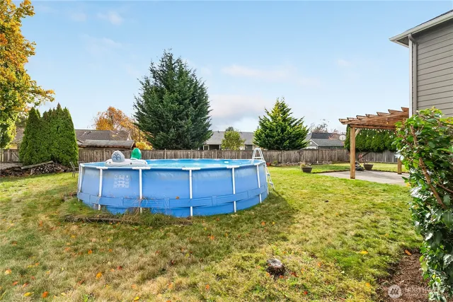 a view of a backyard with potted plants and large tree