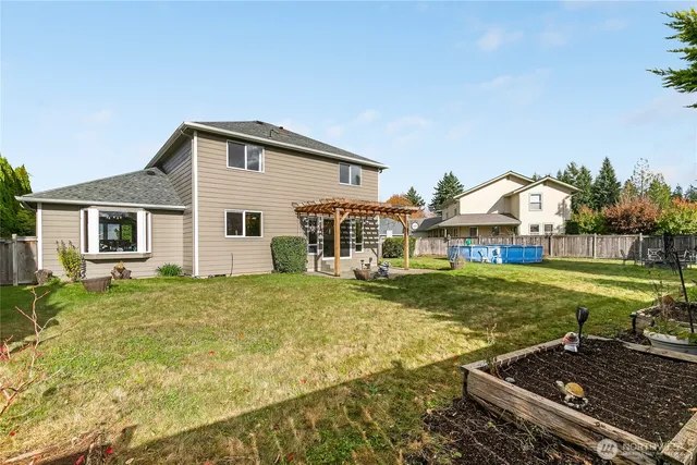 a view of a house with backyard and sitting area