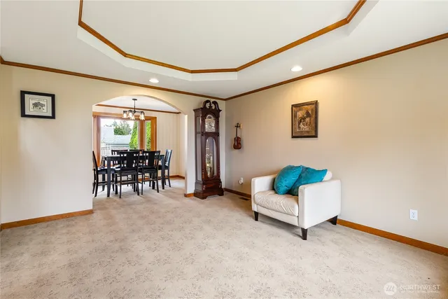 a living room with furniture and a dining table