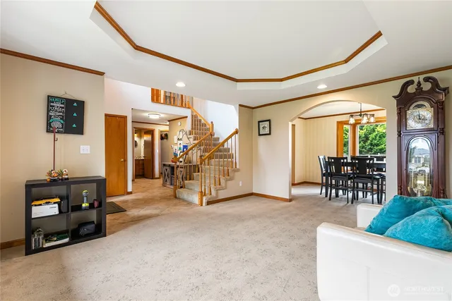a living room with furniture and a dining table