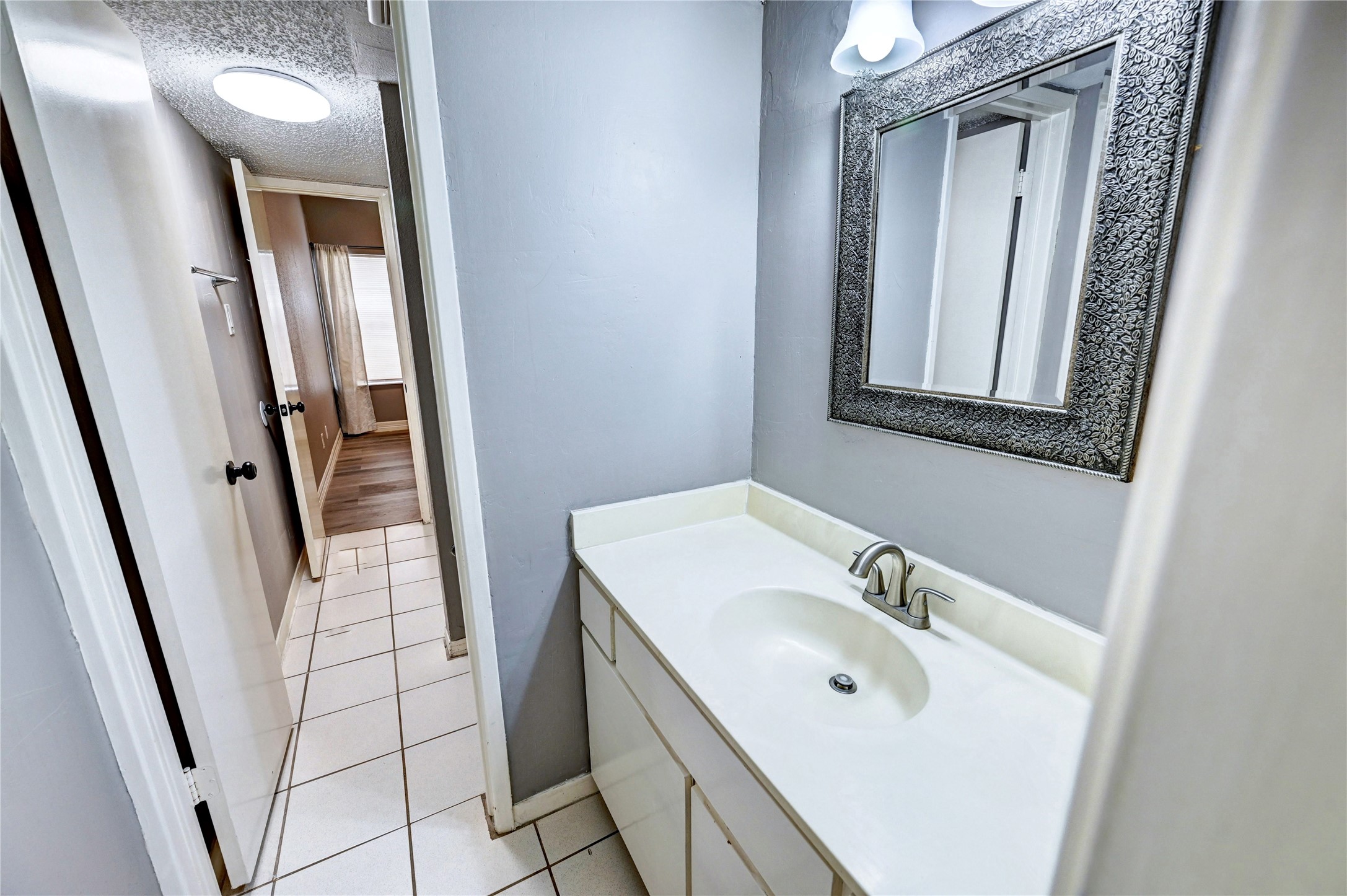 12900 Walden Road, Unit 6 Montgomery, TX 77356 - Photo 22 of 39 Vanity area connecting to the bathroom/living area.