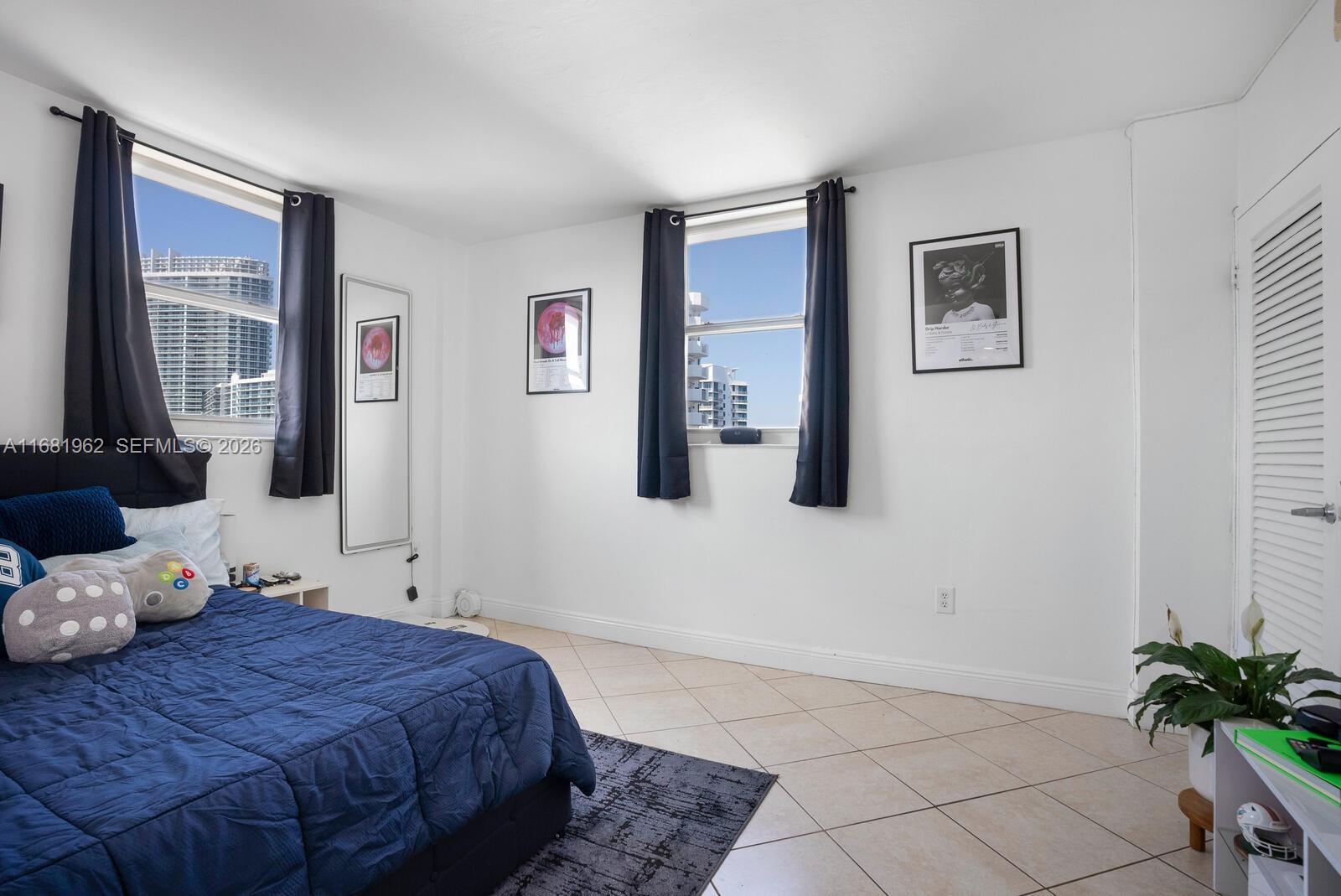 1300 Lincoln Road, Unit A701 Miami Beach, FL 33139 - Photo 12 of 36 a bedroom with a bed and a potted plant