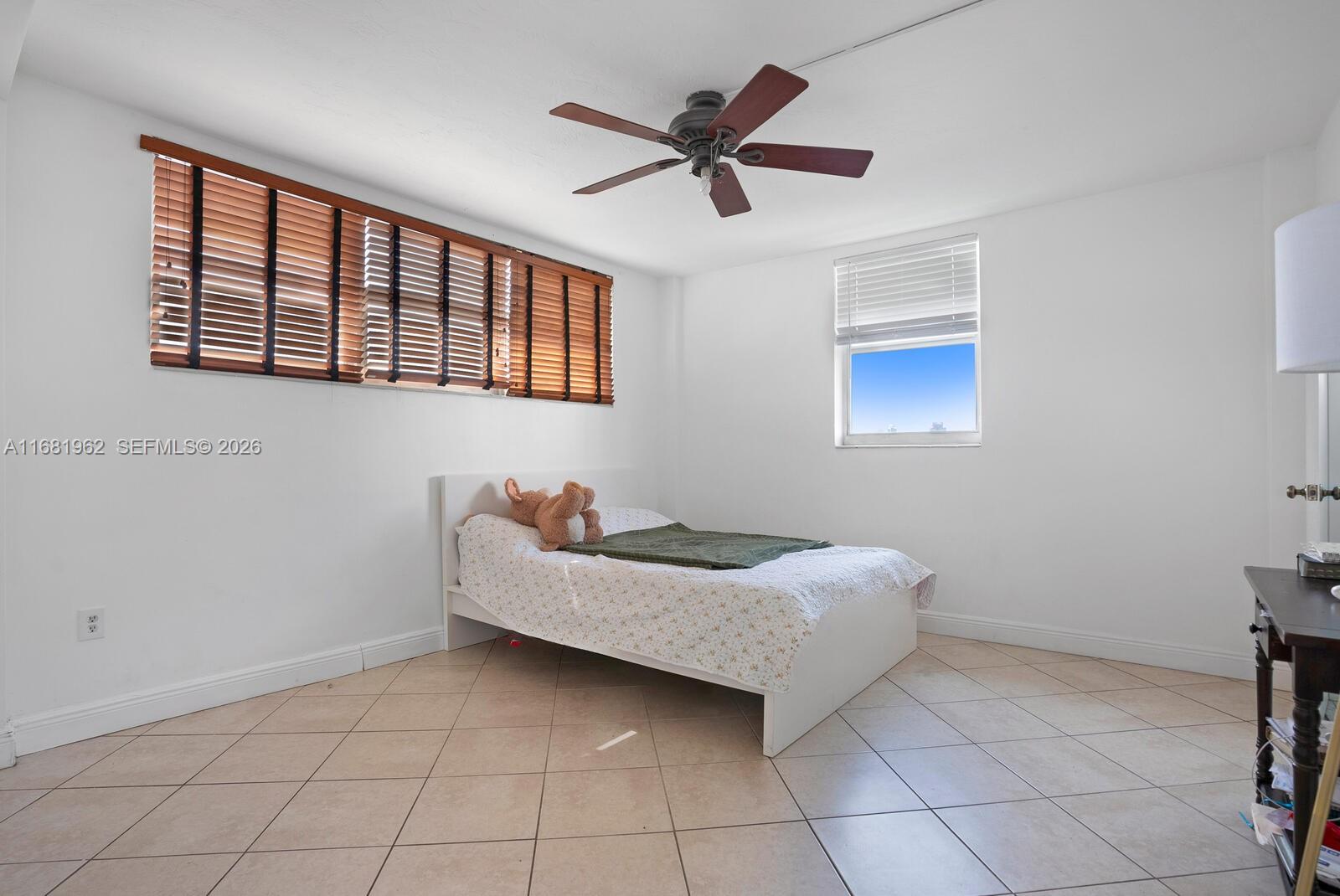1300 Lincoln Road, Unit A701 Miami Beach, FL 33139 - Photo 15 of 36 a living room with a bed furniture and a ceiling fan